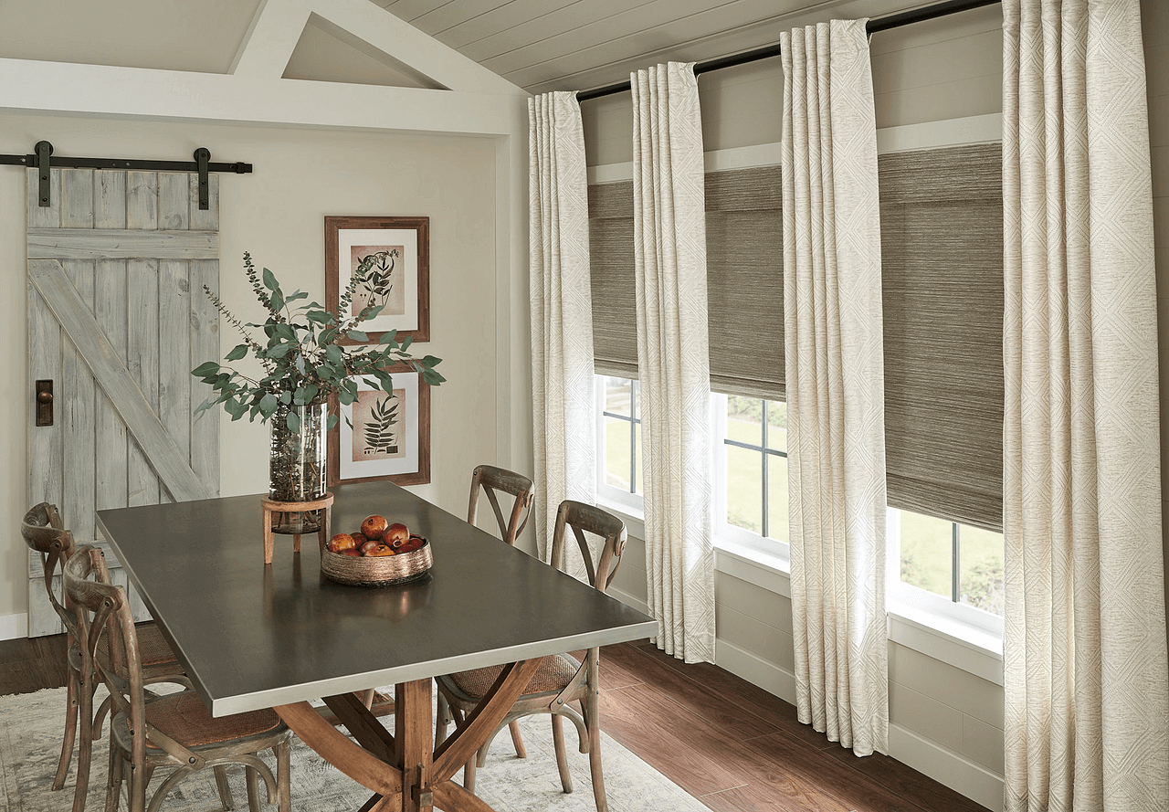 A gorgeous farmhouse styled dining area with cream colored drapes