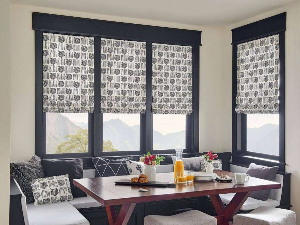 Graber Roman shades elegantly draped in a stylish living room setting