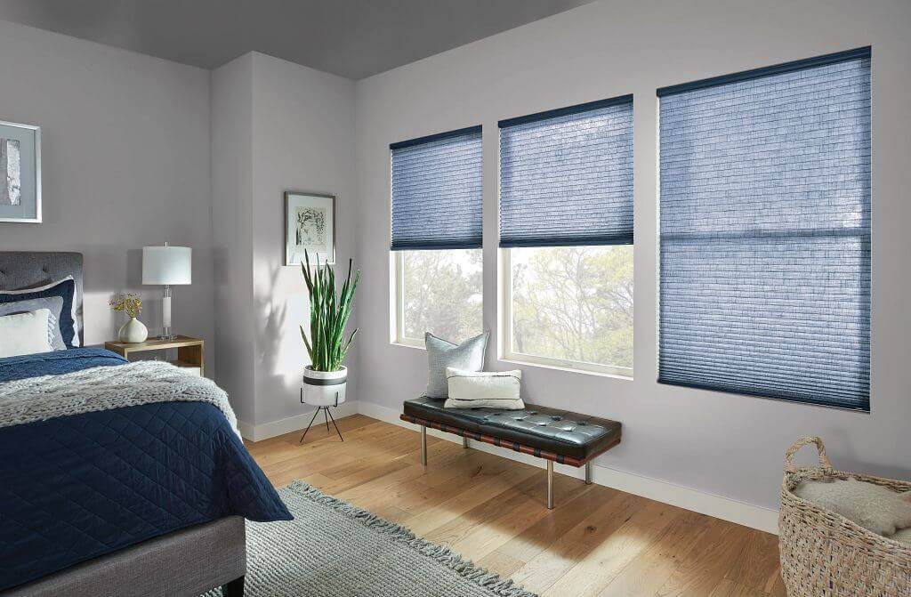 Cellular shades providing privacy and light control in a cozy bedroom